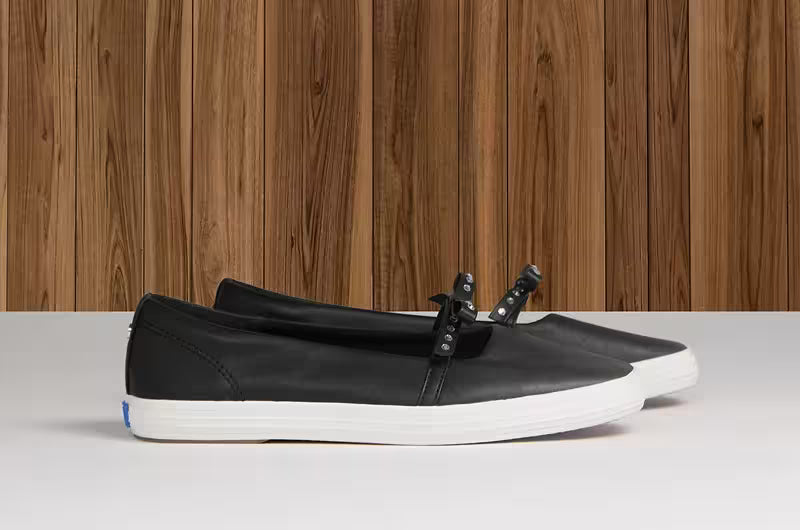 A side view of the Square Toe Mini Bow Leather in black.